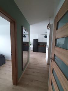 an empty hallway with a door and a mirror at Apartament Number 2 NOVA WOZOWNIA Free Parking in Leszno