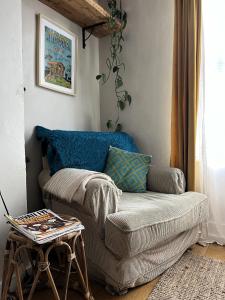 a living room with a couch and a table at Cottage Hideaway with Garden in Bristol