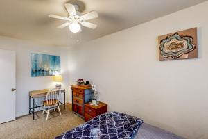 a bedroom with a ceiling fan and a desk at Midtown Hideaway in Coeur d'Alene