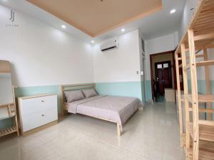 a bedroom with a bed and a staircase in it at My home your home in Ho Chi Minh City