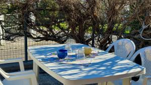 a table with a blue and white table cloth on it at Appartamenti "Le Palme" in Numana