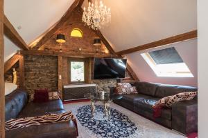 a living room with a couch and a tv at Ferienhaus Kappel mit Pool in Freiburg im Breisgau
