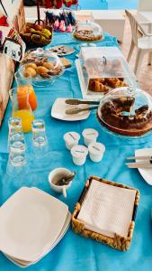 a table with a blue table cloth with food on it at Residence Jolly in Peschici