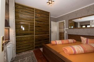 a bedroom with two beds and a large closet at Ferienhaus Kappel mit Pool in Freiburg im Breisgau