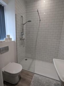 a bathroom with a shower and a toilet and a sink at Contemporary Double Ensuite Room in Birmingham