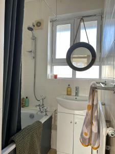a small bathroom with a sink and a shower at Super-convenient, 3 mins to Kings Cross in London