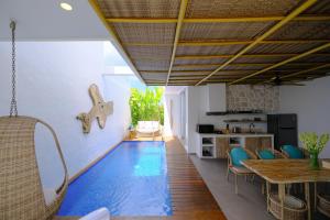 Una sala de estar con una piscina en el piso. en Villa Hanara - Unique 2BR Mediterranean, en Uluwatu