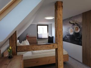 a bedroom with a bunk bed in a attic at Ferienwohnung Andrea in Hasselfelde