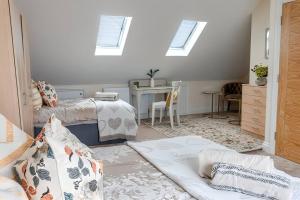 1 Schlafzimmer mit 2 Betten und einem Tisch mit einem Schreibtisch in der Unterkunft Beautiful and spacious home in London