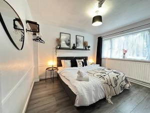 a bedroom with a large bed and a window at Cosy Retreat: Near Attractions & Comfortable! in Birmingham