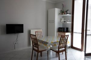 a dining room with a table and two chairs at Casa Le corti in Livorno