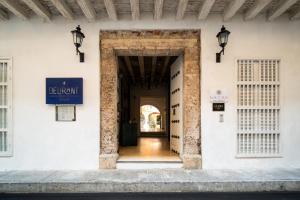 a door to a building with a sign on it at Nacar Hotel Cartagena, Curio Collection by Hilton in Cartagena de Indias