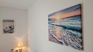 a room with a picture of the beach on the wall at Sea and Sand Apartment Greenn Life in Sozopol