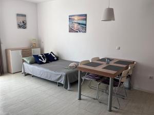 a small room with a bed and a table at Sea and Sand Apartment Greenn Life in Sozopol