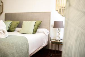 A bed or beds in a room at AZZ Sevilla Torre de la Plata Apartamentos