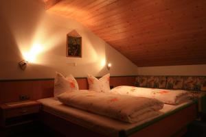 a bed in a room with a wooden ceiling at Große Wohnung in Bach mit Eigenem Balkon in Bach