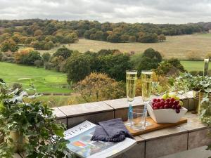 a table with two champagne glasses and a bowl of fruit at richmond park top floor in London