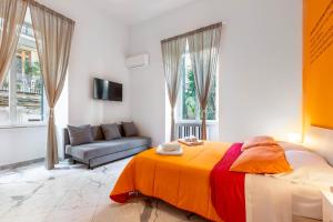 a bedroom with a large bed and a couch at Colori e Note in Naples