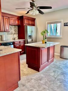 a kitchen with red cabinets and a ceiling fan at Northern Delight in Bloomfield