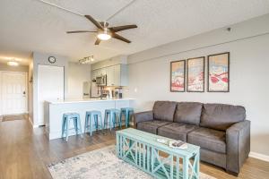 a living room with a couch and a kitchen at Ocean City Studio - Steps to Boardwalk and Beach! in Ocean City