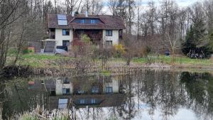 a house is reflected in a body of water at Altmarkblick in Erbenhausen