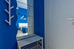 a blue room with a mirror and a blue wall at Colori e Note in Naples +39 photos