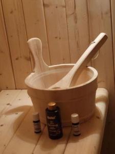 a toilet in a room with two bottles on the floor at Haus am See mit Fasssauna, Liegewiese und Grill in Waldkirchen