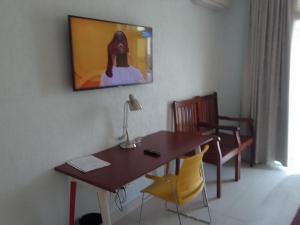 a dining room with a table and yellow chairs at GRAND HOTEL CITY, Douala in Douala