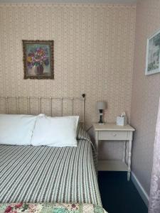 um quarto com uma cama e uma mesa com uma fotografia na parede em Terrace Inn and 1911 Restaurant em Petoskey