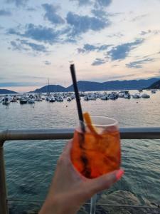 a person holding a drink in front of a marina at Poesia di Lerici in Lerici
