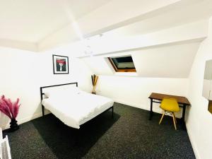 a bedroom with a bed and a desk and a chair at Albert Inn Apartments in Manchester