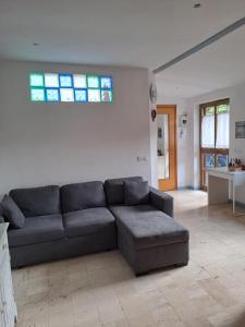 a living room with a couch and a window at Casa Susy in Rome