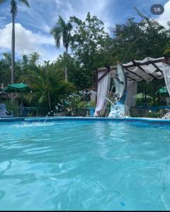 a dolphin fountain in a swimming pool at Hotel las marias de neiba in Cerro en Medio