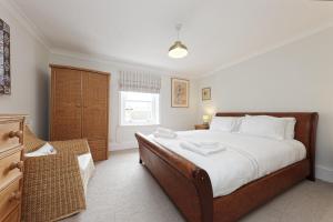 a bedroom with a large bed and a window at Viking Bay View 3 Bed Apartment in Broadstairs