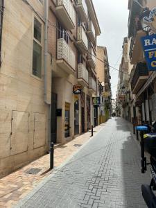 an empty street in an alley between buildings at Vista Corazón in Benidorm +9 photos