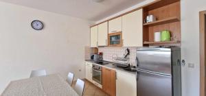 a kitchen with a stainless steel refrigerator and a table at Regina Hungarorum in Međugorje