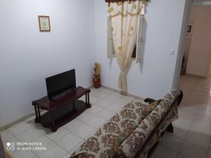 a living room with a couch and a tv at Chez Lopes in Praia