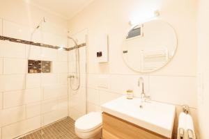 a bathroom with a sink and a toilet and a mirror at Appartement in Winningen mit Terrasse in Winningen