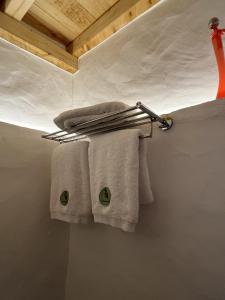 a towel rack in a bathroom with towels on it at Casa de Alcaria in Alcaria
