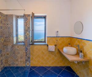 a bathroom with a sink and a shower at Agriturismo Primaluce in Sorrento +39 photos