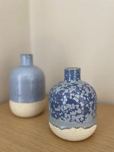two blue and white vases sitting on a table at Bright and cozy apartment near the city center in Zakynthos Town