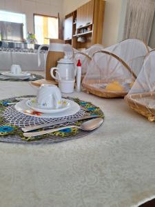 a table with a tea set on top of it at Casa DasCli in Camocim