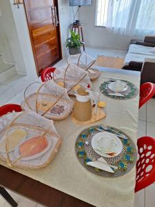 a table with plates and dishes on top of it at Casa DasCli in Camocim