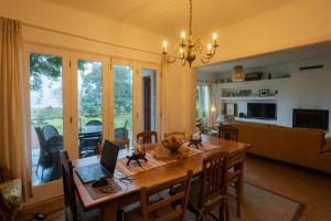 a dining room with a table with a laptop on it at Lake View House in Sete Cidades
