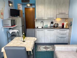 eine kleine Küche mit einem Tisch und einer Mikrowelle in der Unterkunft Casa Carlotta in San Bartolomeo al Mare