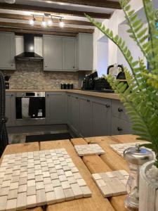 a kitchen with a wooden table and a counter top at Leven's Rest - 2 Bed Maisonette in Backbarrow