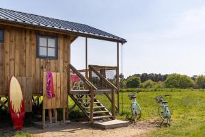 a wooden cabin with two bikes parked next to it at Dihan Evasion in Ploemel