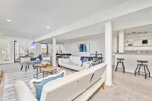 a living room with white furniture and a kitchen at Hillside vacation next to Overland Park Kansas nature trail grill and fun in Stilwell