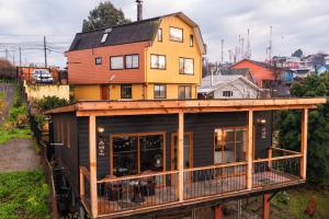 a building with a house on top of it at Cabaña rustica con vista al mar in Puerto Montt