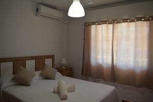 a bedroom with a bed with two towels on it at Nonna Beach Apartment Two-Bedroom Sea Views 50 m from the Beach Wifi in Rincón de la Victoria
